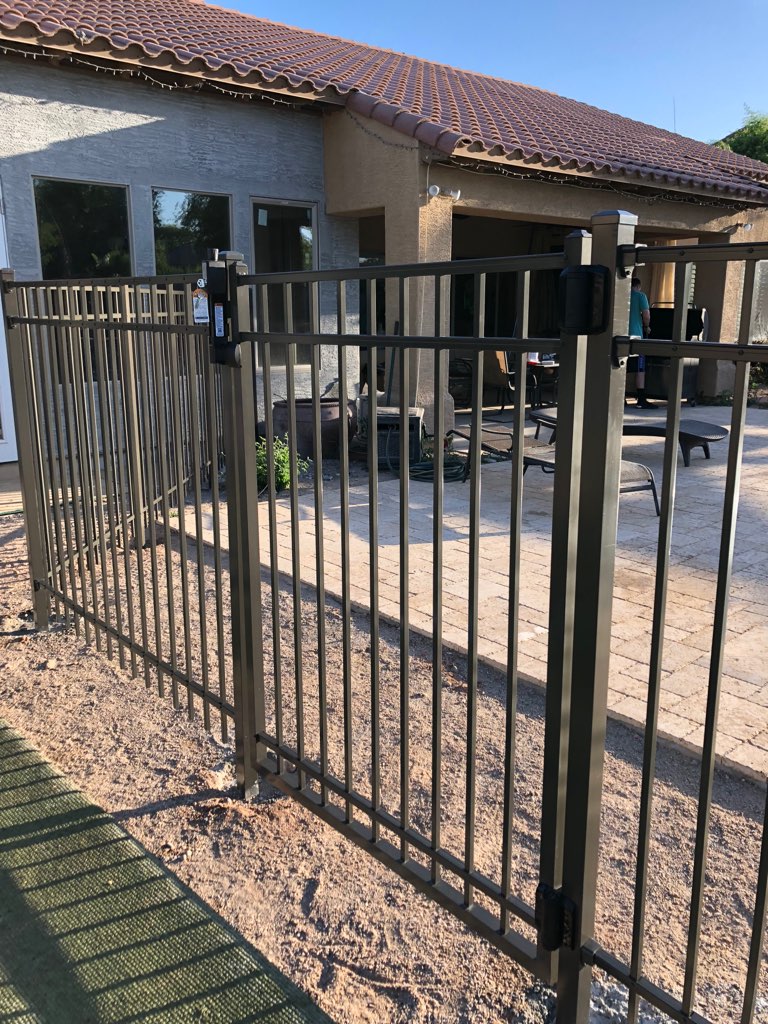 iron pool safety gate on fence