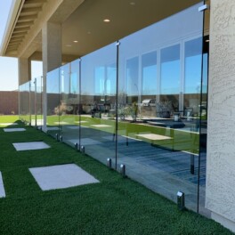 glass fence installation between patio stucco walls
