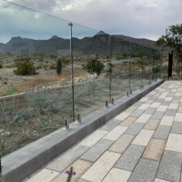 looking through glass fence to see desert mountain views