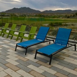 Pool deck lounge chairs with glass fence and unobstructed mountain views