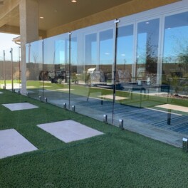 glass frameless fence patio barrier installed on turf