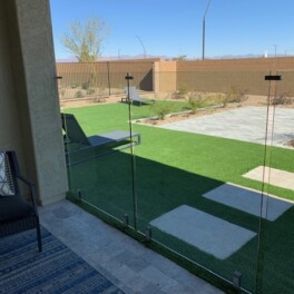 glass pool fenced connected to stucco column