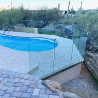 Glass fence around pool with unobstructed views of desert landscape