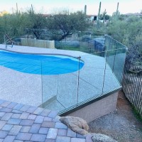 Glass fence around pool with unobstructed views of desert landscape