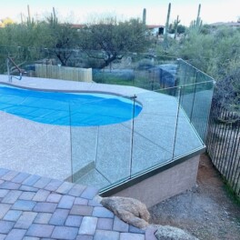 Glass fence around pool with unobstructed views of desert landscape