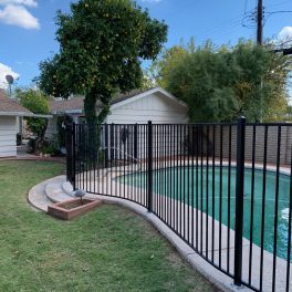 black iron pool fence with curves