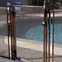 A pool gate with a self-closing device installed. Self-Closing and Self-Latching Pool Gate